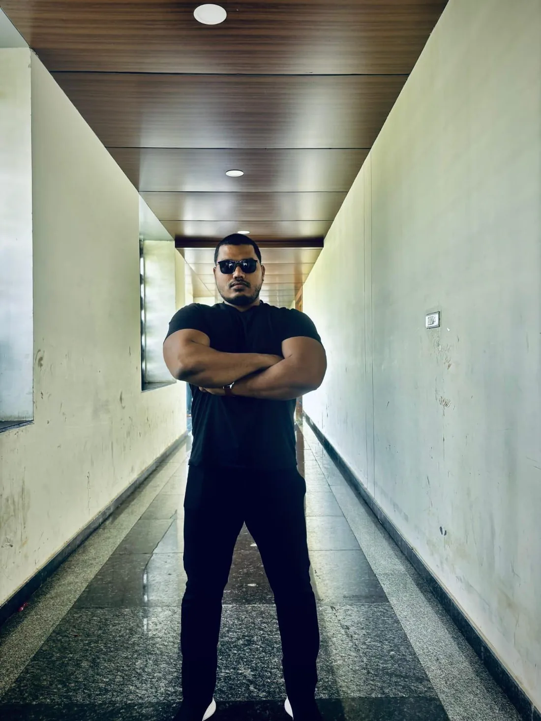 Security officer with sunglasses, arms crossed